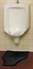 A Picture of product 528-103 UriGard® U for Urinals.  Disposable Floor Mat. Protects floor from urine drips, splash and stain. Features NABC Fresh Scent fragrance.  6/carton.
